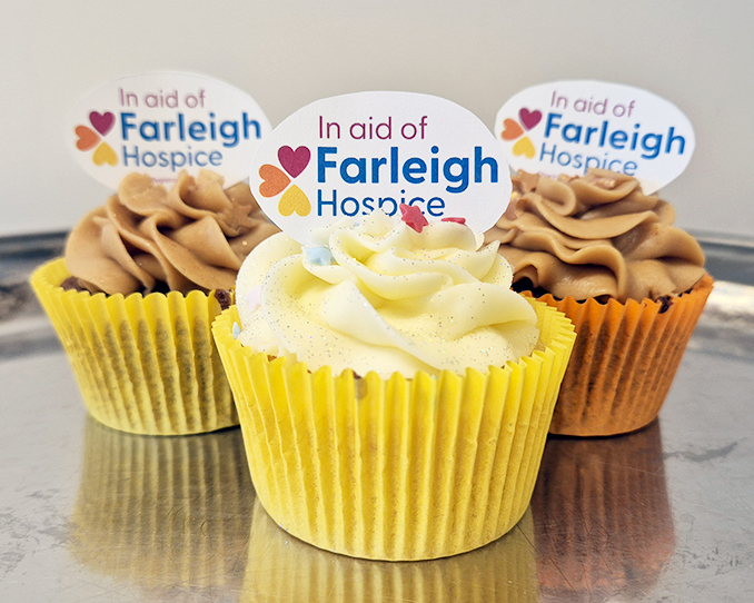 Three iced cupcakes with Farleigh Hospice branded toppers