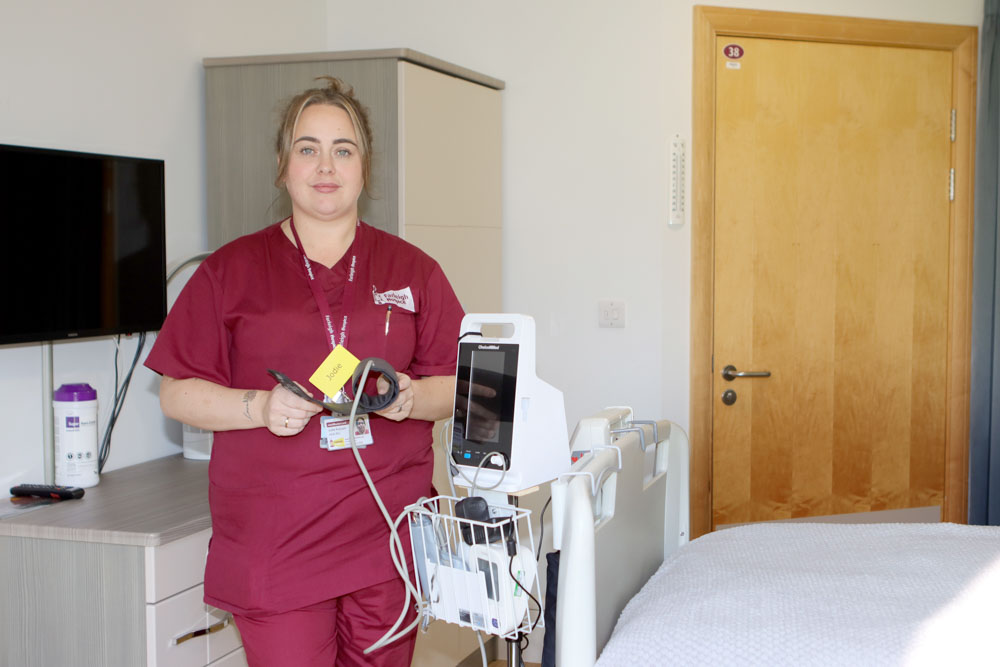Female IPU nurse with blood pressure machine