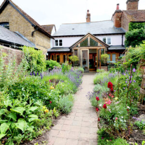 A cottage garden with stone path and summer flowers