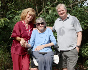 MND patient supported by her husband and Farleigh Hospice nurse.