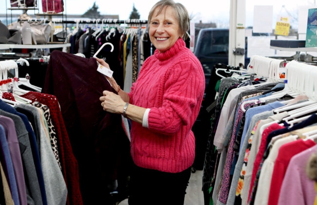 Farleigh Hospice retail volunteer sorting clothing inside a one of our shops