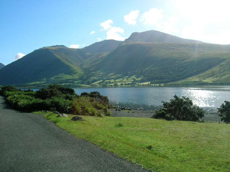 A view of a mountain and lake in sunshine