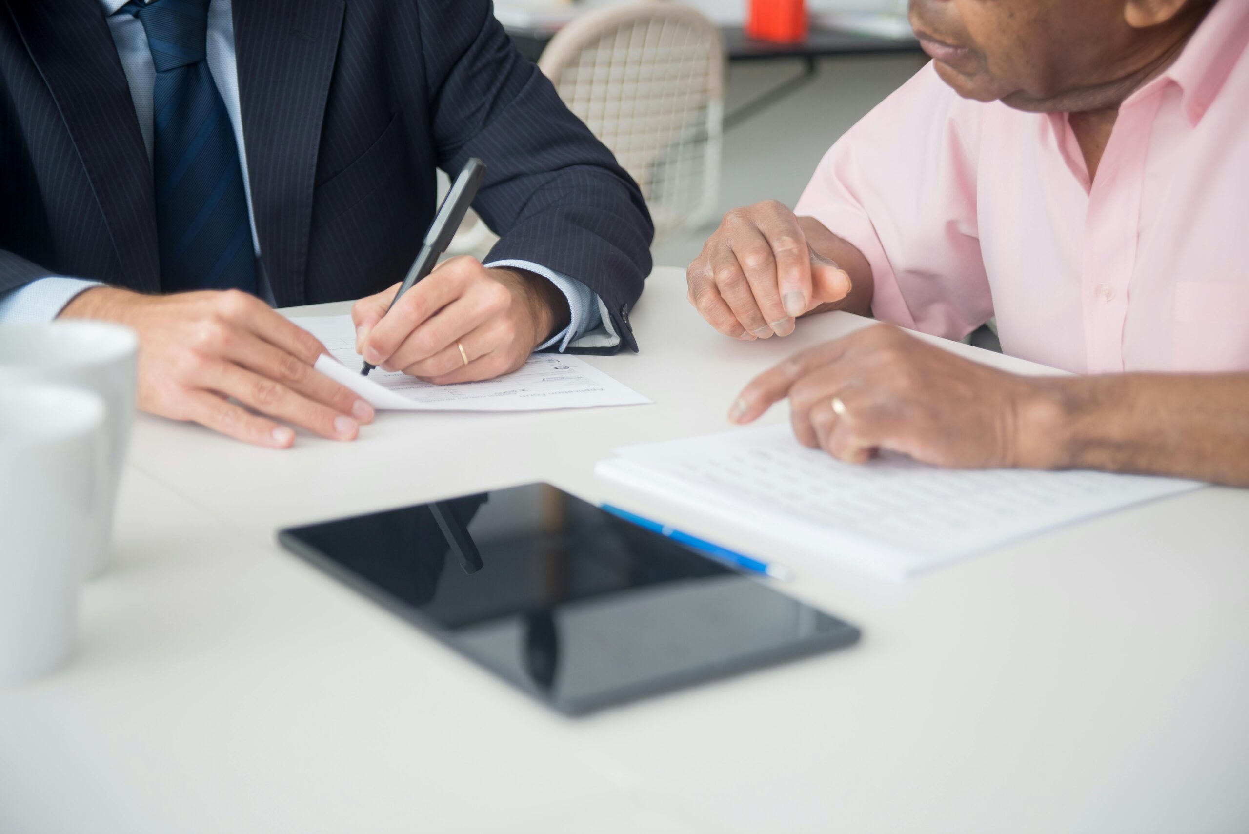 Person reviewing a Will document while discussing leaving a gift to charity.